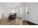 Bright dining area with wood floors and a stylish light fixture, perfect for Gathering meals at 5332 Seaspray Ln, Raleigh, NC 27610