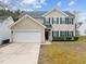Charming two-story home features a two-car garage, blue shutters, and well-maintained landscaping at 5332 Seaspray Ln, Raleigh, NC 27610