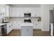Stylish kitchen showcasing white cabinets, a kitchen island, and stainless steel appliances at 5332 Seaspray Ln, Raleigh, NC 27610
