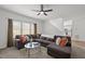 Cozy living room with a large sectional, ceiling fan and large window, creating a relaxing space at 5332 Seaspray Ln, Raleigh, NC 27610