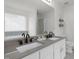 Elegant main bathroom featuring dual sinks, a large mirror, and modern fixtures at 5332 Seaspray Ln, Raleigh, NC 27610