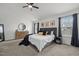 Spacious main bedroom features a ceiling fan, neutral walls, plush carpet, and decor in a modern style at 5332 Seaspray Ln, Raleigh, NC 27610