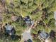 Aerial view of a home surrounded by lush trees in a quiet neighborhood at 5504 Quails Call Ct, Garner, NC 27529
