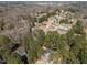 Wide aerial view showcasing multiple houses amidst verdant trees, creating a peaceful neighborhood setting at 5504 Quails Call Ct, Garner, NC 27529
