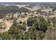 Expansive aerial view of a tranquil neighborhood with mature trees, winding roads, and serene ponds at 5504 Quails Call Ct, Garner, NC 27529