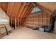 Unfinished attic space ready for customization with exposed rafters and shelving at 5504 Quails Call Ct, Garner, NC 27529