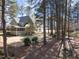 Expansive backyard with mature trees and a charming screened porch, perfect for outdoor living at 5504 Quails Call Ct, Garner, NC 27529