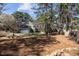 Spacious backyard featuring mature trees with lush greenery, offering a serene and private outdoor space at 5504 Quails Call Ct, Garner, NC 27529