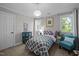 Cozy bedroom with a pendant light, accent chair, and natural light from windows at 5504 Quails Call Ct, Garner, NC 27529