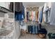 Walk-in closet with shelving, hanging rods and neatly organized clothing at 5504 Quails Call Ct, Garner, NC 27529
