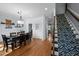 Open-concept dining area with hardwood floors and access to the staircase and other rooms at 5504 Quails Call Ct, Garner, NC 27529