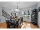 Bright dining room with large windows, elegant lighting, and stylish table setting at 5504 Quails Call Ct, Garner, NC 27529