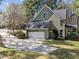 Home exterior showcases a spacious driveway leading to an attached garage and well-maintained landscaping at 5504 Quails Call Ct, Garner, NC 27529