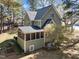 Detailed view of home's back exterior featuring a screened porch and meticulous landscaping at 5504 Quails Call Ct, Garner, NC 27529