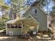 View of the exterior featuring a screened porch, well-maintained lawn, and lush landscaping at 5504 Quails Call Ct, Garner, NC 27529