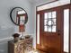 Inviting foyer with a stylish mirror, decorative console table, and hardwood flooring at 5504 Quails Call Ct, Garner, NC 27529