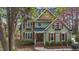 Charming two-story home featuring a gabled roof, wood shutters and trim, and manicured landscaping at 5504 Quails Call Ct, Garner, NC 27529