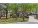 Two-story home with wood shutters and trim, gabled roof, mature trees, and private driveway at 5504 Quails Call Ct, Garner, NC 27529