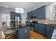 Beautiful kitchen featuring dark blue cabinetry, granite countertops, and stainless steel appliances at 5504 Quails Call Ct, Garner, NC 27529