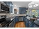 Modern kitchen with stainless steel appliances, granite countertops, and custom cabinetry at 5504 Quails Call Ct, Garner, NC 27529