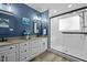Main bathroom suite with double sinks, white cabinetry, and a glass-enclosed shower at 5504 Quails Call Ct, Garner, NC 27529