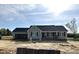 Charming single-story home featuring a neutral gray exterior, black shutters and a spacious attached garage at 56 N Movado Trl, Kenly, NC 27542