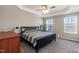 Comfortable bedroom with ceiling fan, neutral walls, and plenty of natural light at 5917 Kayton St, Raleigh, NC 27616