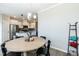 The dining room overlooks the modern kitchen with stainless steel appliances and white cabinetry at 5917 Kayton St, Raleigh, NC 27616