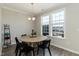 The dining room is bright with natural light, hardwood floors, and modern furnishings at 5917 Kayton St, Raleigh, NC 27616