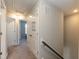 Upstairs hallway with carpet flooring leads to the bedrooms and bathrooms in the home at 5917 Kayton St, Raleigh, NC 27616