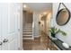 Bright hallway featuring hardwood floors, stairs to the upper level, and modern decor at 5917 Kayton St, Raleigh, NC 27616