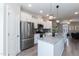 Bright kitchen features white cabinetry, stainless steel appliances, granite countertops, and an eat-in island at 5917 Kayton St, Raleigh, NC 27616