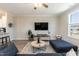Spacious living room with modern furnishings and a mounted television at 5917 Kayton St, Raleigh, NC 27616