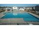 Aerial view of community pool with a clubhouse, lounge areas, and neatly arranged homes at 5917 Kayton St, Raleigh, NC 27616
