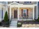 Inviting covered porch with brick facade and space for outdoor seating at 5917 Kayton St, Raleigh, NC 27616