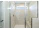 Modern walk-in shower featuring beige subway tile, a built-in bench, and a glass door at 5917 Kayton St, Raleigh, NC 27616