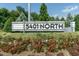 Entrance Sign: '5401 North' with lush landscaping and colorful flowers at 5917 Kayton St, Raleigh, NC 27616