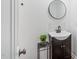 Bathroom vanity featuring a black faucet, round mirror, white subway tile backsplash and dark cabinet at 608 N 15Th St, Erwin, NC 28339