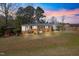 Charming brick home featuring a covered porch, carport, and a small backyard gazebo at 608 N 15Th St, Erwin, NC 28339