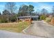 Charming brick home featuring covered front porch and a long drive way with an attached garage at 608 N 15Th St, Erwin, NC 28339