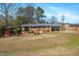 Charming single-story brick home with covered parking, screened in porch and a spacious front yard at 608 N 15Th St, Erwin, NC 28339