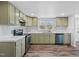 Charming kitchen featuring light green cabinets, stainless steel appliances, and wood-look floors at 608 N 15Th St, Erwin, NC 28339