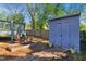 Landscaped backyard featuring a garden, shed and deck, creating a serene outdoor living space at 611 S Buchanan Blvd, Durham, NC 27701