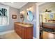 Elegant bathroom featuring double sinks, granite countertop, and a view into the bedroom at 611 S Buchanan Blvd, Durham, NC 27701