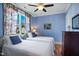 Cozy bedroom featuring twin beds, blue accent pillows, and a serene atmosphere at 611 S Buchanan Blvd, Durham, NC 27701