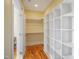 Spacious walk-in closet boasting built-in shelving and ample storage space at 611 S Buchanan Blvd, Durham, NC 27701