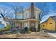 Charming two-story home with a brick chimney, inviting front porch, and a beautiful garden area at 611 S Buchanan Blvd, Durham, NC 27701