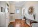 Inviting foyer features hardwood floors, a striking mirror, and classic architectural details, creating a warm welcome at 611 S Buchanan Blvd, Durham, NC 27701