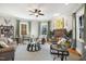 Bright living room features a fireplace, ceiling fan, and ample natural light, creating a welcoming atmosphere at 611 S Buchanan Blvd, Durham, NC 27701