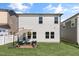 Spacious backyard featuring an outdoor seating area with a patio umbrella at 625 Sage Oak Ln, Holly Springs, NC 27540